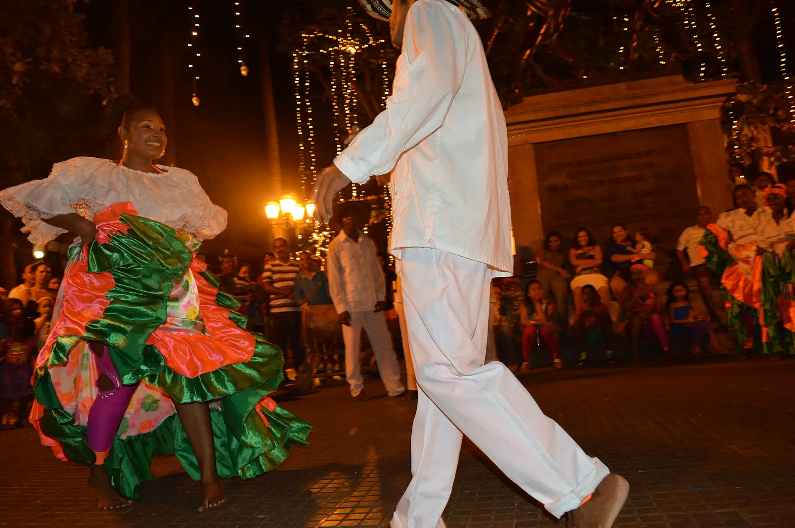 Dancers in traditional dress on a Cartagena street, not a studio salsa class