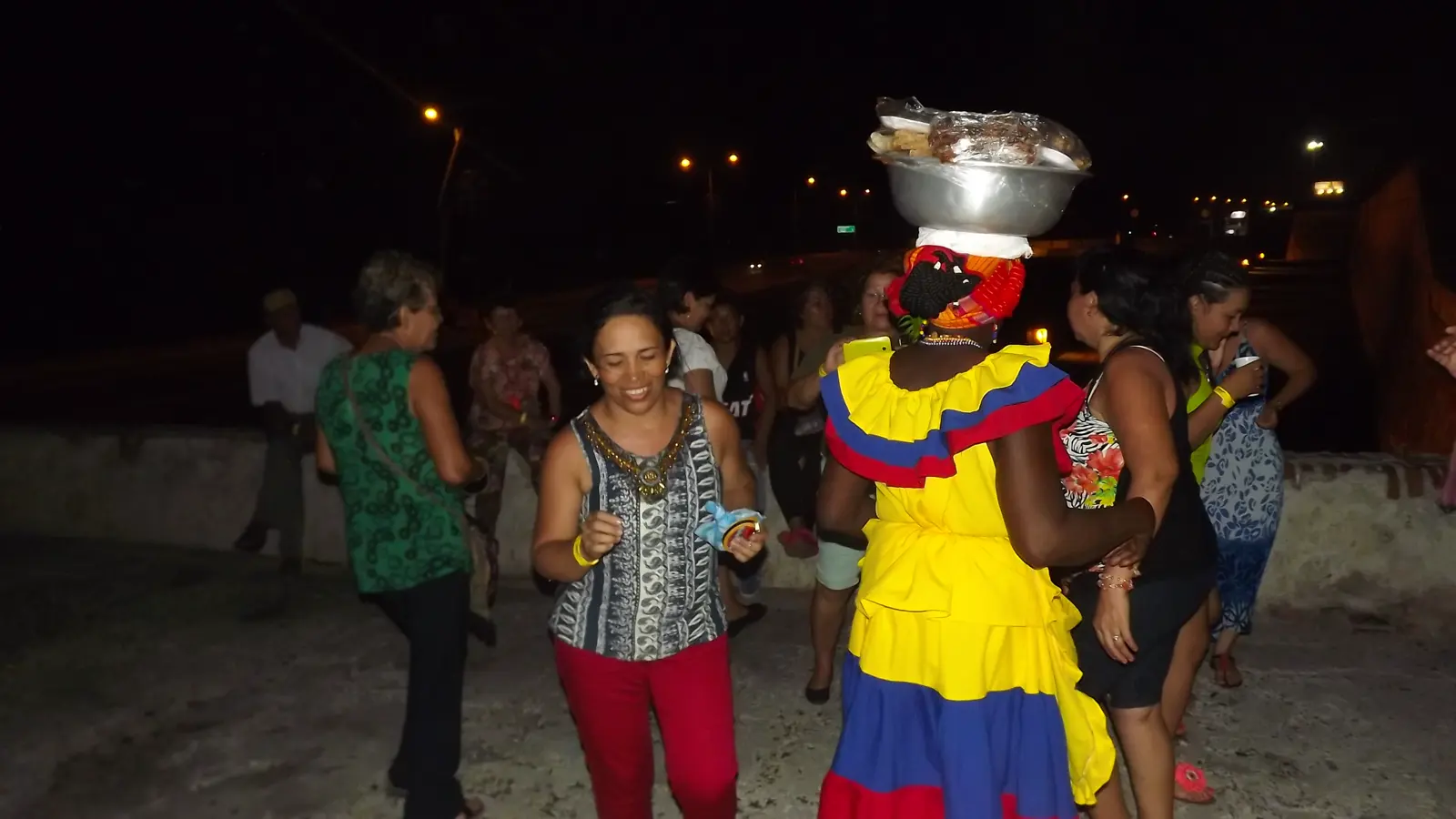 People on Cartagena's city walls at night